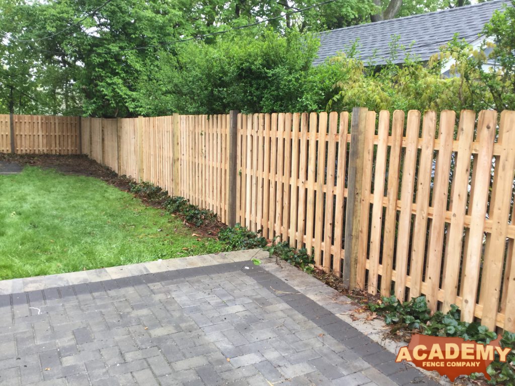 This is a board on board or shadowbox, cedar, wood privacy fence.