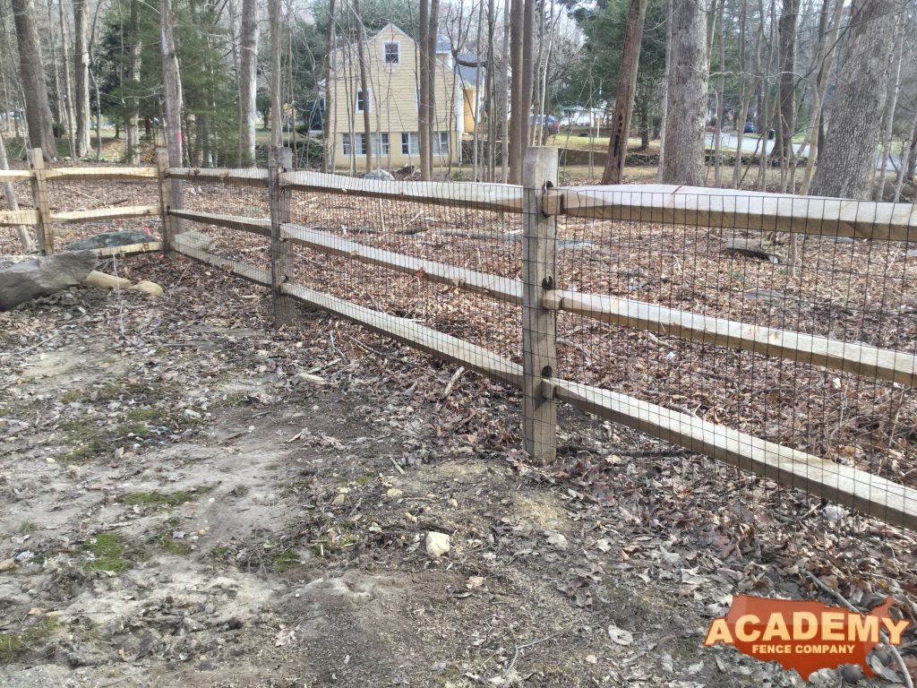 Post and rail with welded wire mesh attached installed by Academy Fence Company in West Caldwell, NJ.