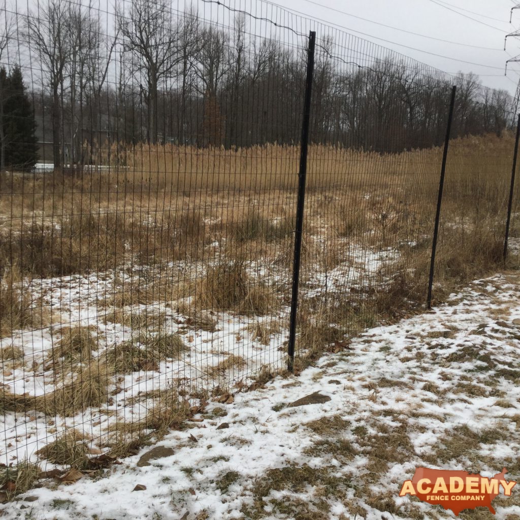 8′ high black wire deer fence installed in Warren, NJ, by Academy Fence Company.