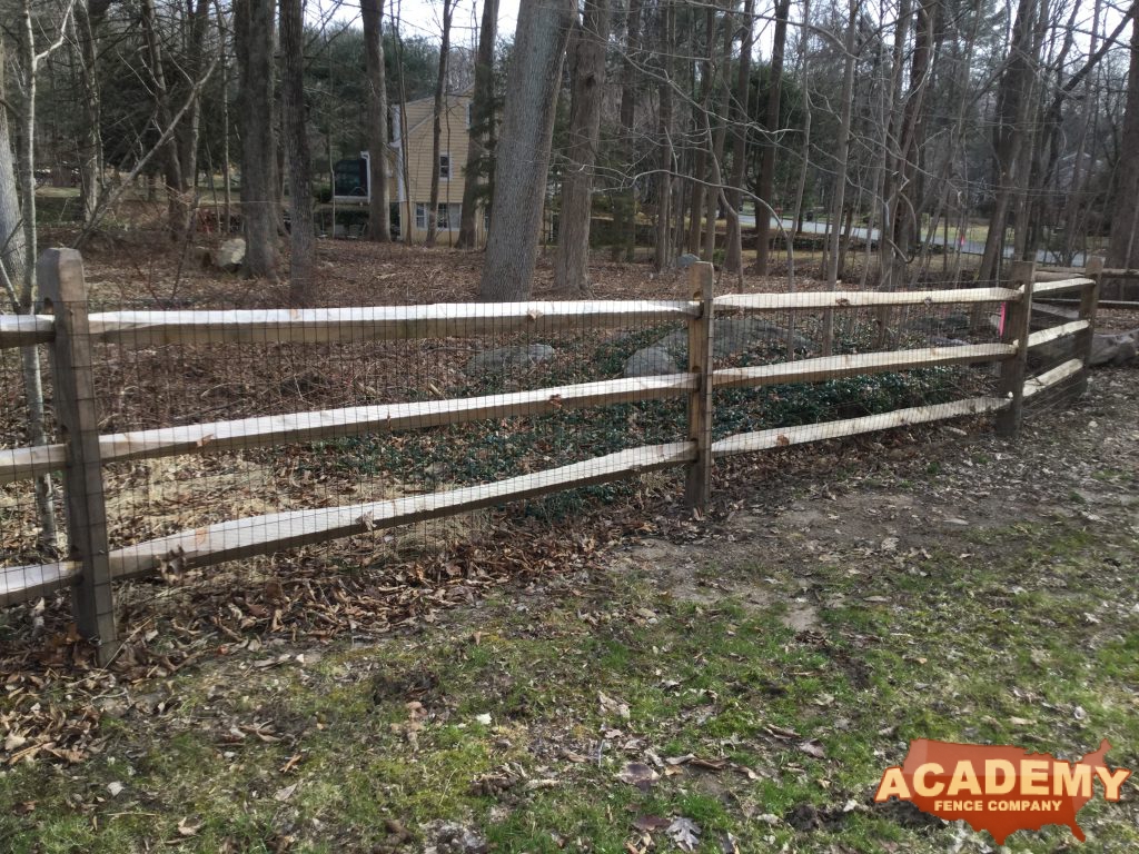 This is a rustic split, post and rail, wood fence, with welded wire mesh attached, that we install in Morristown, Morris County, NJ